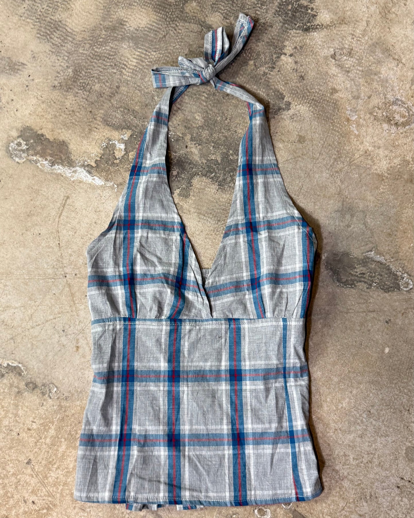 Plaid halter top on a textured concrete surface
