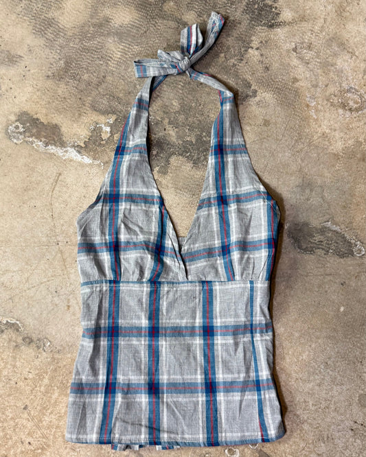 Plaid halter top on a textured concrete surface